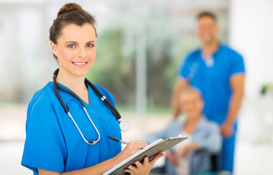 young medical doctor writing on clipboard